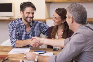 Couple coming to an agreement with businessman