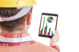 Contractor holding tablet checking his finance