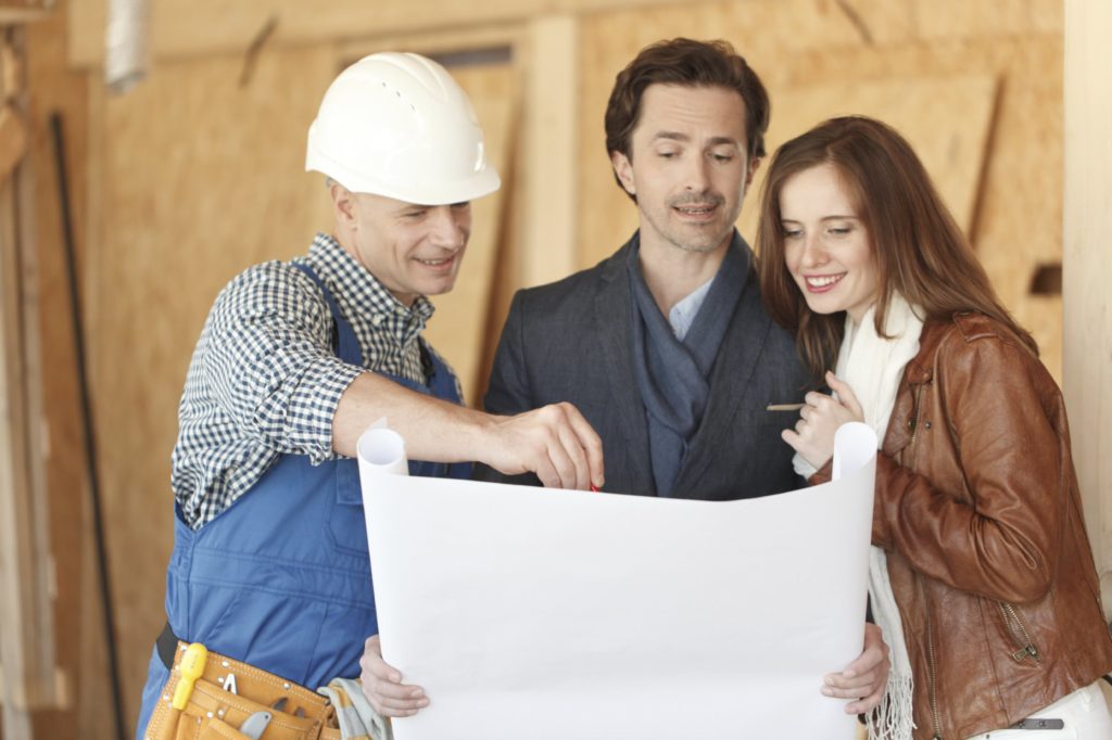 Contractor going over their home project plans with the homeowners