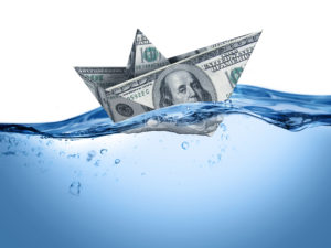 Dollar bill boat on water