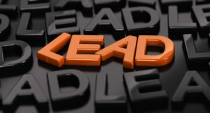 Orange word "lead" with black words surrounding a black background