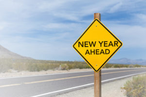 New Year Ahead sign in front of road landscape