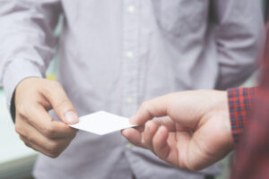 Close up of businessman handing a customer a business card