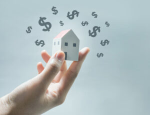 House model on human hands with dollar icon