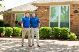 Smiling businessmen standing outside of a home