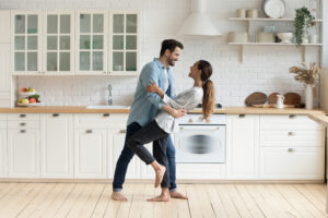 Man and women dancing in the kitchen