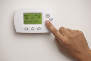 Thermostat with a hand, set to 78 degrees Fahrenheit