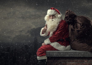 Santa Claus on the roof bringing gifts on Christmas Eve