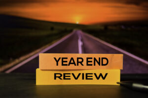 Year End Review written on sticky notes with a road in the background