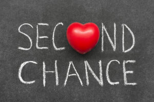 Second chance written on blackboard with heart symbol instead of O