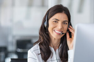Business women with headset talking on the phone smiling