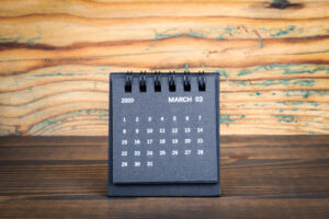 Black paper calendar on a wooden table