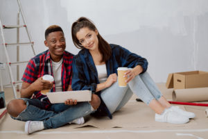 Couple sitting in middle of home improvement project