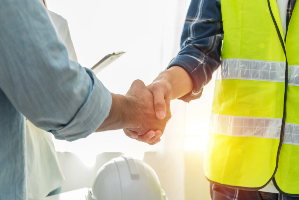 Home improvement contractor shaking hands over sales pitch