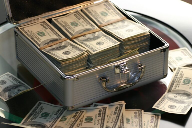 Stack of money inside of a briefcase to pay contractor for home improvement job