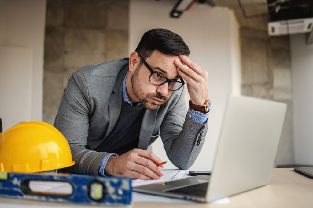 Businessman for contractor that is stressed over losing sales